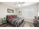 Cozy bedroom featuring gray and white bedding, shuttered windows, and wood-look flooring at 2306 Valley Cottage Ave, Henderson, NV 89052