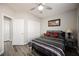 Well-lit bedroom includes two closets, gray and white bedding, and wood-look flooring at 2306 Valley Cottage Ave, Henderson, NV 89052