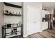 Stylish dining area features a bar cart, shelving with wine storage, and a closet for extra storage at 2306 Valley Cottage Ave, Henderson, NV 89052