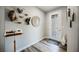 Inviting entryway featuring a decorative glass door, wood-look floors, and eclectic wall decor at 2306 Valley Cottage Ave, Henderson, NV 89052