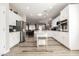 Bright, open kitchen boasts stainless steel appliances, white cabinetry, and a functional center island at 2306 Valley Cottage Ave, Henderson, NV 89052