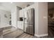 Kitchen with large stainless steel refrigerator, white cabinets, and island at 2306 Valley Cottage Ave, Henderson, NV 89052