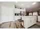 Open kitchen with white cabinetry, stainless steel refrigerator, and a central island with seating at 2306 Valley Cottage Ave, Henderson, NV 89052