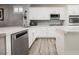 Modern kitchen featuring white cabinetry, stainless steel appliances, and sleek countertops with a stylish backsplash at 2306 Valley Cottage Ave, Henderson, NV 89052
