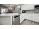 Well-appointed kitchen showcasing stainless steel appliances, white cabinets, and modern fixtures, perfect for cooking at 2306 Valley Cottage Ave, Henderson, NV 89052