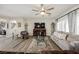 Bright living room with a ceiling fan, comfortable seating, and a decorative cabinet at 2306 Valley Cottage Ave, Henderson, NV 89052