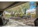 The spacious covered patio has brick pavers, a ceiling fan, and plenty of seating to enjoy the backyard at 2306 Valley Cottage Ave, Henderson, NV 89052