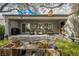 Relaxing covered patio with comfortable seating, a grill, brick flooring, and lush planters offering a serene outdoor space at 2306 Valley Cottage Ave, Henderson, NV 89052