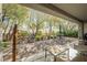This covered brick-paver patio with a shady arbor, outdoor furniture, and lush landscaping is perfect for relaxing outdoors at 2306 Valley Cottage Ave, Henderson, NV 89052