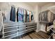 Organized walk-in closet featuring custom shelving, rods for hanging, and wood-look floors at 2306 Valley Cottage Ave, Henderson, NV 89052