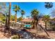 A beautiful pool area surrounded by mature palm trees and lush landscaping offers residents a relaxing outdoor retreat at 231 W Horizon Ridge Pkwy # 1011, Henderson, NV 89012