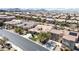 An elevated shot of the house and adjacent homes, with desert landscaping and mountain views at 2665 Chateau Clermont St, Henderson, NV 89044