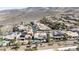A high angle shot of a community of homes with landscaping, set against a backdrop of mountains in the distance at 2665 Chateau Clermont St, Henderson, NV 89044