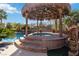 Backyard featuring a spa, tiki hut, and tropical landscaping at 2665 Chateau Clermont St, Henderson, NV 89044