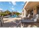 Backyard with a pool, tiki hut, lounge chairs, and covered patio at 2665 Chateau Clermont St, Henderson, NV 89044