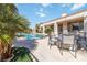 Well-manicured outdoor living area with a pool, patio, and mature landscaping at 2665 Chateau Clermont St, Henderson, NV 89044