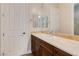 Bathroom with vanity, granite counters, decorative mirror, and white door at 2665 Chateau Clermont St, Henderson, NV 89044