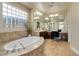 Bright bathroom with a soaking tub, natural light, and double sinks with desk at 2665 Chateau Clermont St, Henderson, NV 89044