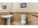 Elegant powder room featuring a pedestal sink, decorative tile and wall accents at 2665 Chateau Clermont St, Henderson, NV 89044