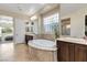 Bright bathroom with a soaking tub, natural light, and double sinks at 2665 Chateau Clermont St, Henderson, NV 89044