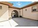 Exterior view of an arched gate leading to a serene courtyard with desert plants at 2665 Chateau Clermont St, Henderson, NV 89044
