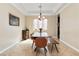 Traditional dining room boasts neutral walls, a long wood table, and large stained glass window at 2665 Chateau Clermont St, Henderson, NV 89044