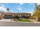 Attractive single-story home featuring a tile roof, arched entrance, and lush, low-water landscaping at 2665 Chateau Clermont St, Henderson, NV 89044