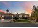 Inviting single-story home with a tile roof, arched entryway, and desert-style front yard under evening sky at 2665 Chateau Clermont St, Henderson, NV 89044