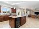 Open kitchen features a center island with a built in wine cooler and bar stool seating at 2665 Chateau Clermont St, Henderson, NV 89044