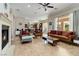 Bright living room with fireplace, high ceilings, and seamless access to the kitchen at 2665 Chateau Clermont St, Henderson, NV 89044