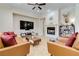 Spacious living room features fireplace, high ceilings, tan couches and open access at 2665 Chateau Clermont St, Henderson, NV 89044