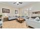 Bright living room featuring tile floors, plantation shutters, and contemporary furnishings at 2665 Chateau Clermont St, Henderson, NV 89044