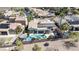 Aerial view of a private backyard oasis featuring a pool, shaded patio, and lush landscaping in a secure, fenced yard at 2665 Chateau Clermont St, Henderson, NV 89044