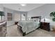 Spacious bedroom with a decorative lamp on a nightstand, a bed with nice linens, and three large windows at 2709 Rue Montpellier Ave, Henderson, NV 89044