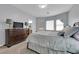 Bedroom with three large windows, a bed with nice linens, a dresser and a TV at 2709 Rue Montpellier Ave, Henderson, NV 89044