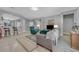 Open-concept living room with neutral tones, tile floors, and modern furnishings at 2709 Rue Montpellier Ave, Henderson, NV 89044