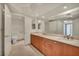 Bright bathroom featuring double sinks, wood cabinets, and large mirrors at 2777 Paradise Rd # 301, Las Vegas, NV 89109