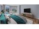 Bright bedroom with teal bedding and a private balcony overlooking the pool, offering a relaxing retreat at 2777 Paradise Rd # 301, Las Vegas, NV 89109