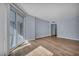 Light-filled room with wide-plank wood floors and large glass door to the balcony at 2777 Paradise Rd # 301, Las Vegas, NV 89109