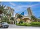 Elegant building entrance surrounded by palm trees and lush landscaping, creating a welcoming atmosphere at 2777 Paradise Rd # 301, Las Vegas, NV 89109