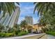 Grand building entrance framed by towering palm trees and modern architecture, embodying luxury living at 2777 Paradise Rd # 301, Las Vegas, NV 89109