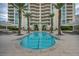 Community pool surrounded by palm trees and a modern high-rise, perfect for relaxation at 2777 Paradise Rd # 301, Las Vegas, NV 89109