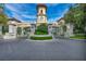 Impressive gated entrance with manicured landscaping and a clock tower, showcasing luxury and elegance at 2777 Paradise Rd # 301, Las Vegas, NV 89109