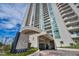 Elegant high-rise exterior showing the building facade and entrance, accented by manicured landscaping and blue sky at 2777 Paradise Rd # 301, Las Vegas, NV 89109