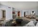 Open living space with wood floors and a seating area near a kitchen with barstool seating at 2777 Paradise Rd # 301, Las Vegas, NV 89109