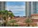 Rooftop view of terracotta tiling, palm trees, and surrounding high-rise buildings at 2777 Paradise Rd # 301, Las Vegas, NV 89109