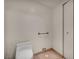 Modern toilet room featuring beige tile flooring, white walls, and a toilet at 2777 Paradise Rd # 301, Las Vegas, NV 89109