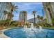 Lush landscaping surrounds water feature in a community near high-rise buildings and a sunny blue sky at 2777 Paradise Rd # 301, Las Vegas, NV 89109