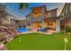 Gorgeous backyard with a pool, putting green, and covered patio, perfect for entertaining at 28 Vista Outlook St, Henderson, NV 89011