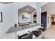Wet bar with granite countertops and modern stools at 28 Vista Outlook St, Henderson, NV 89011